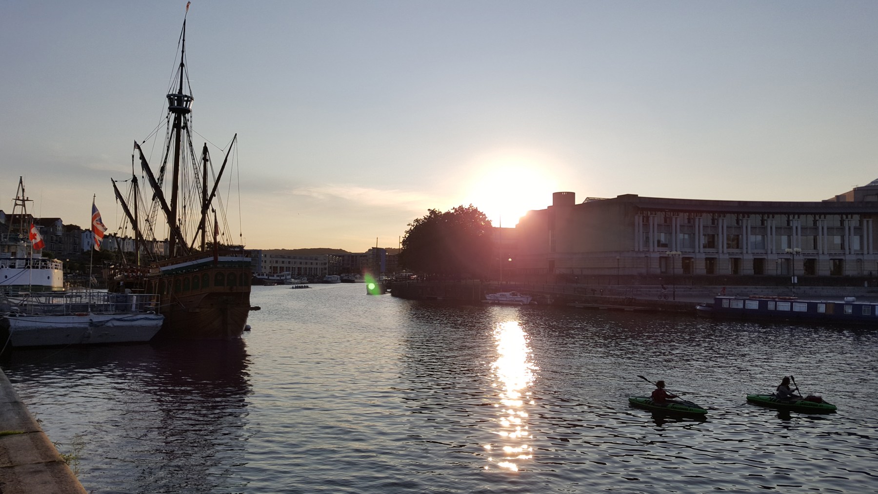 Boats and waterfront buildings beside Bristol’s Floating Harbour at sunset